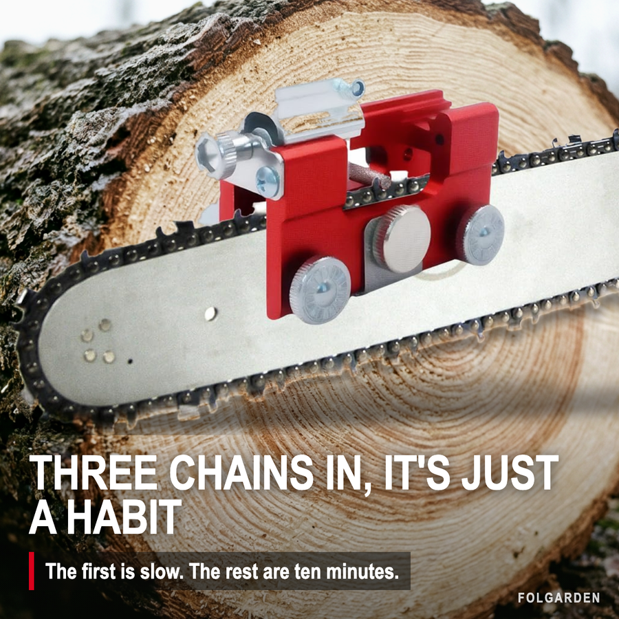 The sharpener fitted to a chainsaw bar, set down on a cut log