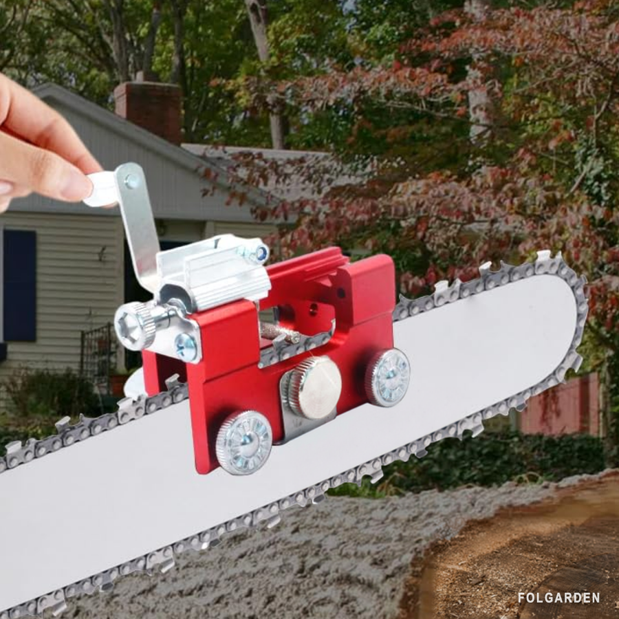 A hand turning the crank outdoors with the sharpener clamped to a chainsaw bar