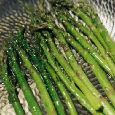 Salmon and vegetables cooking in the hammered titanium pan